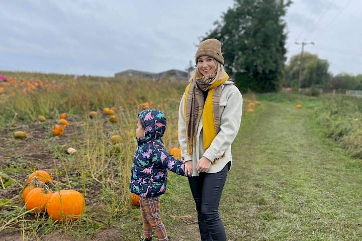 Mother and daughter pumpkin picking.