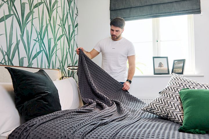 A male making a bed